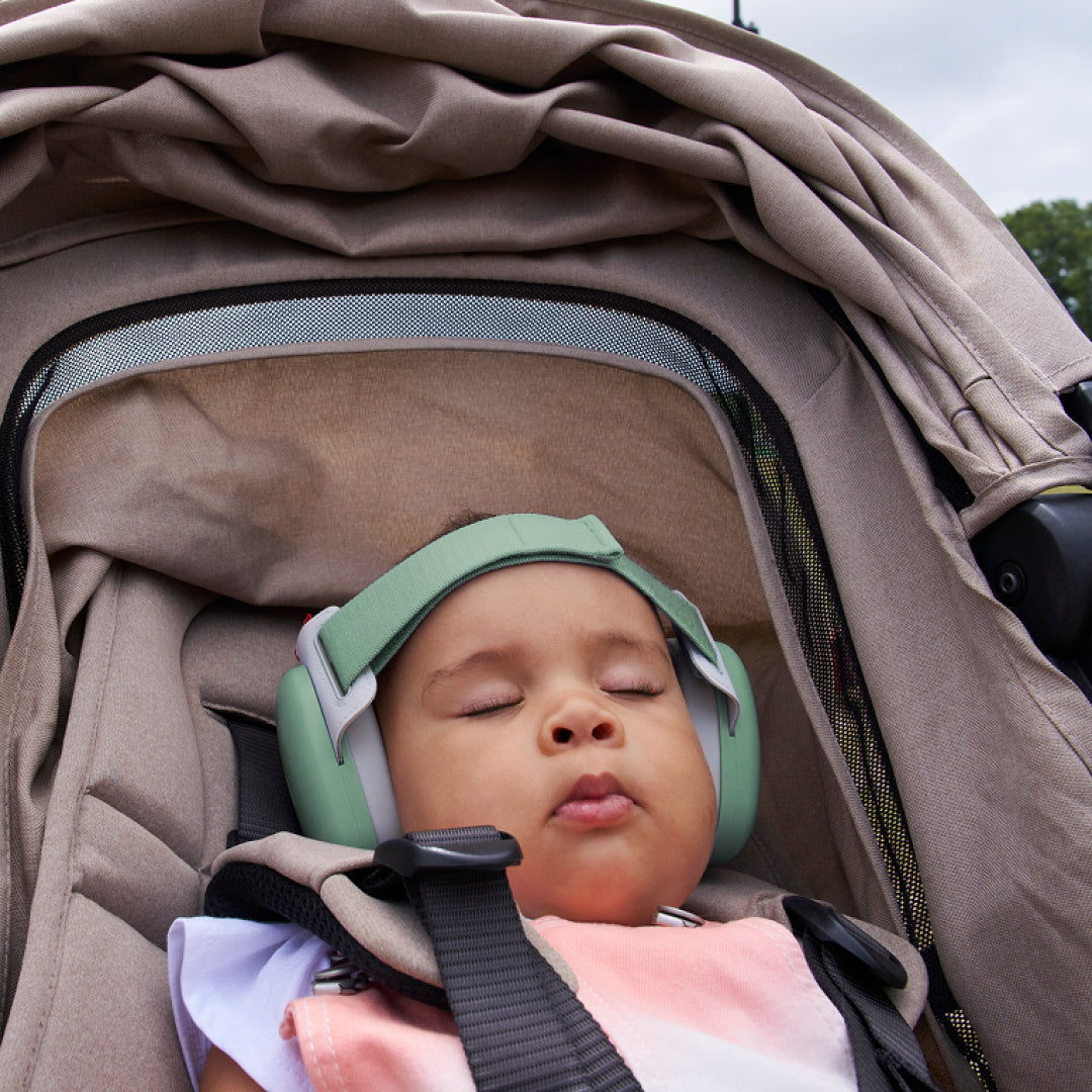 Baby sleeping while wearing muffy baby in sage-green 