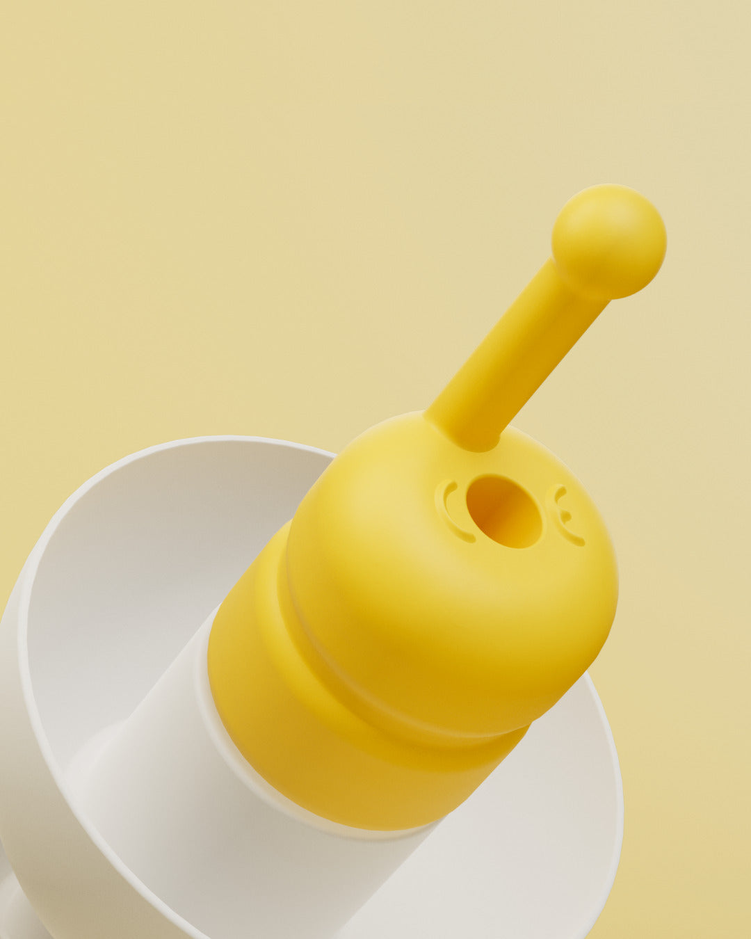 Alpine FlyFit close-up of the yellow filter with central opening and pull stem on a white earplug 